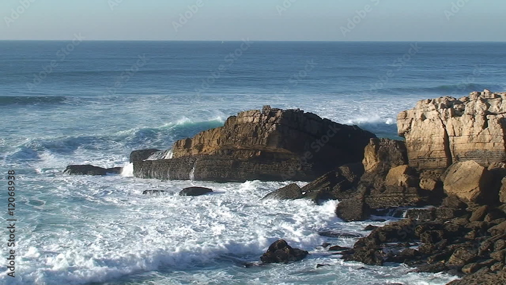 Agitated sea waves against rocks in the beach Agitated sea waves against rocks in the beach