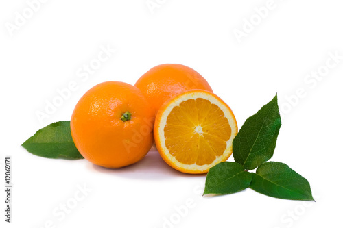 Some oranges with green leaves isolated objects