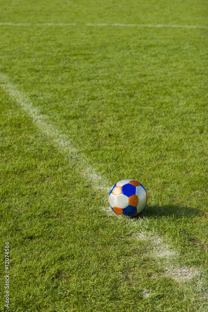 Fototapeta premium Ball in the stadium at the center on green grass field