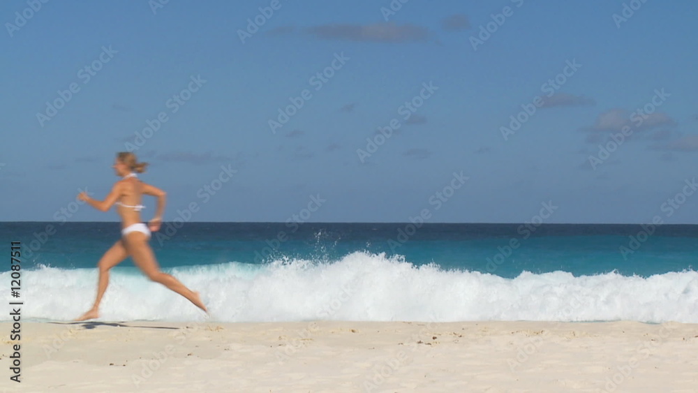 woman in white bikini jumping on beach, slomo woman in white bikini jumping on beach, slomo