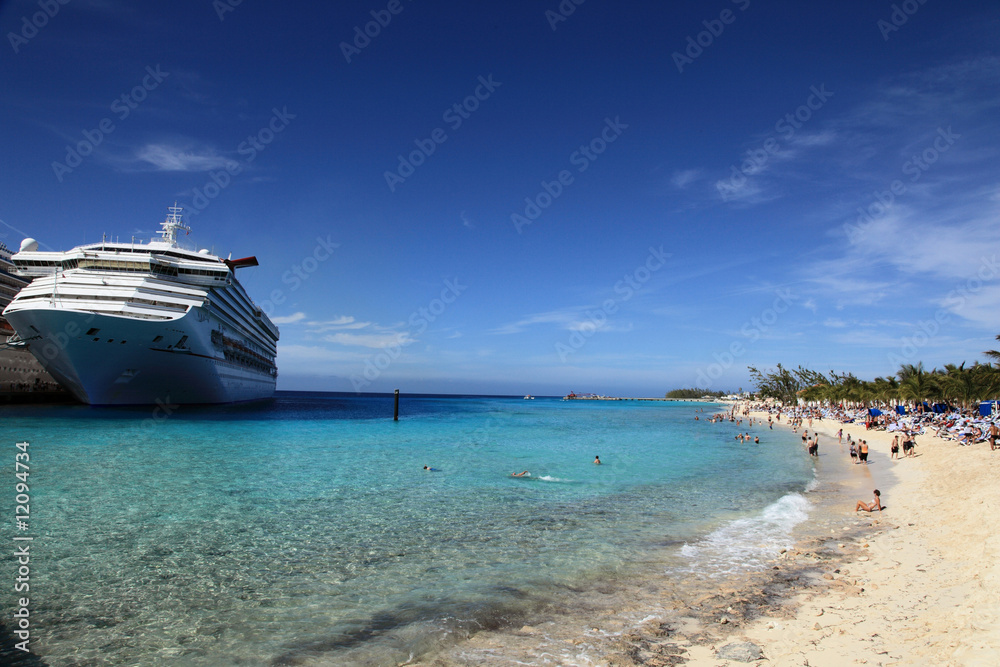 Cruise ship docked in tropical island beach port Cruise ship docked in tropical island beach port