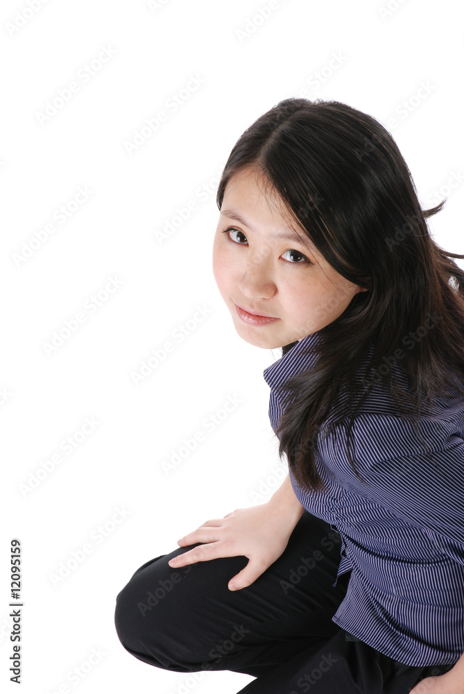 Young chinese girl squatting on the floor Young chinese girl squatting on the floor