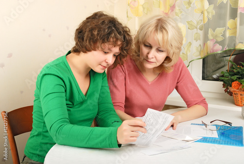 Adult and young women with documents