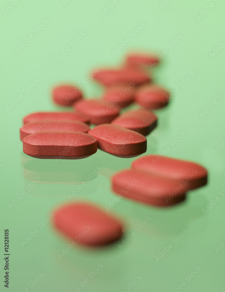 Red pills toward green background Red pills toward green background