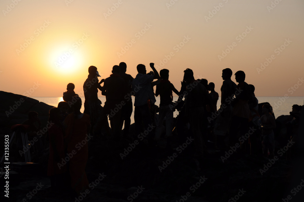 Silhouette dance team people. sunset on the sea