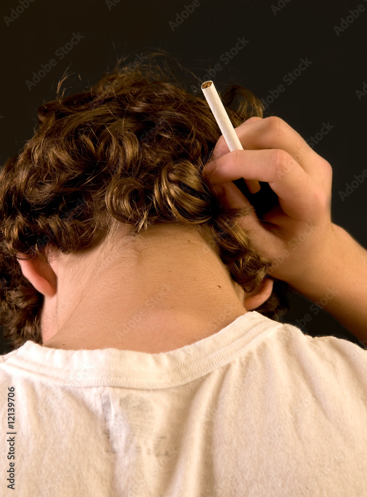Obraz premium Teen smoker - closeup of back of head, with cigarette