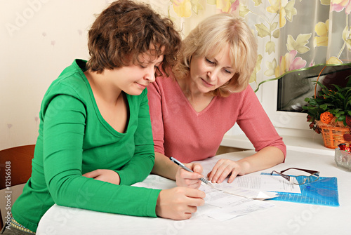 Adult and young women with documents