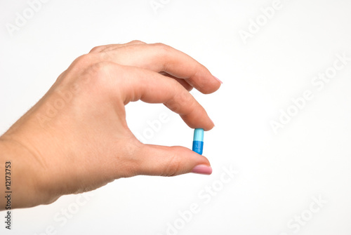 Hand holding a pill