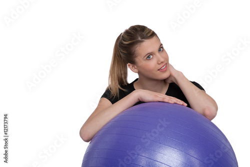 Beautiful woman with purple fitness ball