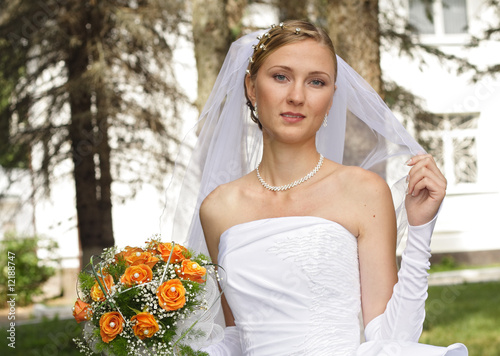 Beautiful bride with bouquet in sunny day