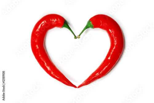 Two chili peppers forming a shape of heart. Hot lover symbol.