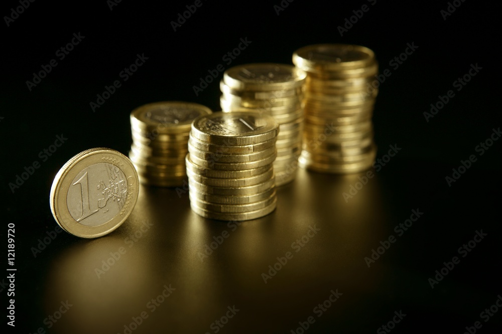 Euro currency coin columns with golden reflections Euro currency coin columns with golden reflections