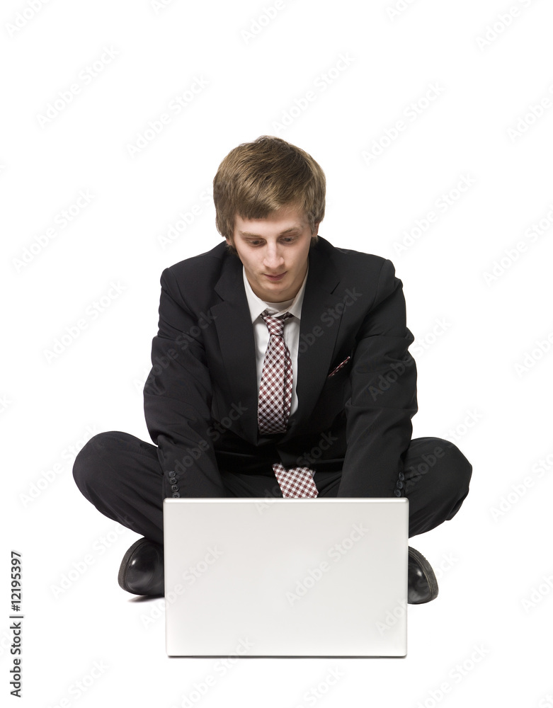 Man sitting on the floor with a computer Man sitting on the floor with a computer