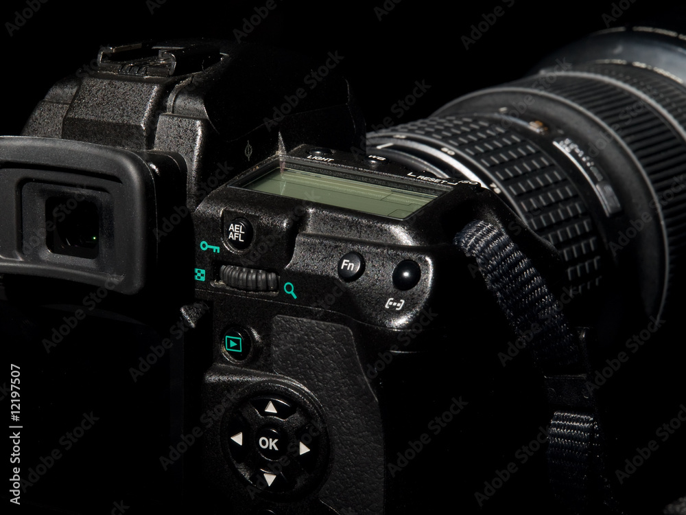 Digital photo camera with big lens in dark tone.