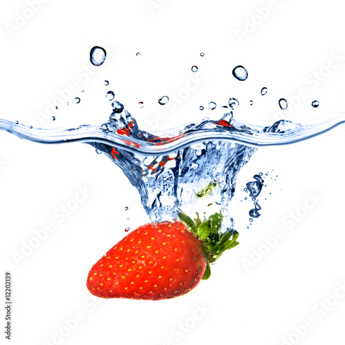 strawberry dropped into blue water with splash isolated on white