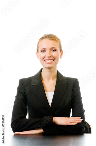 Young happy smiling businesswoman sitting at table