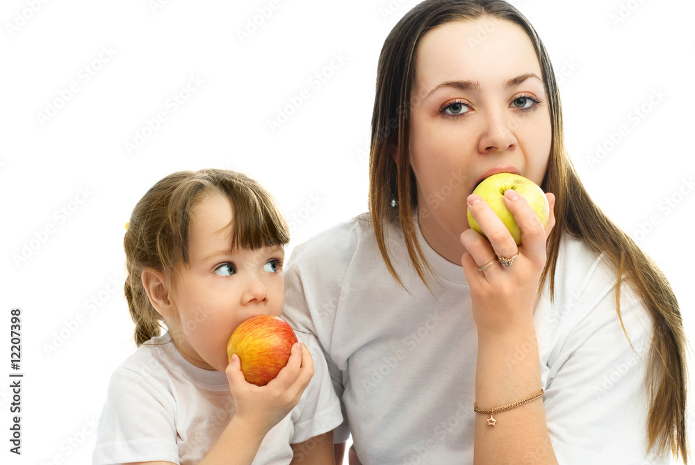 mother and daughter eating apples mother and daughter eating apples