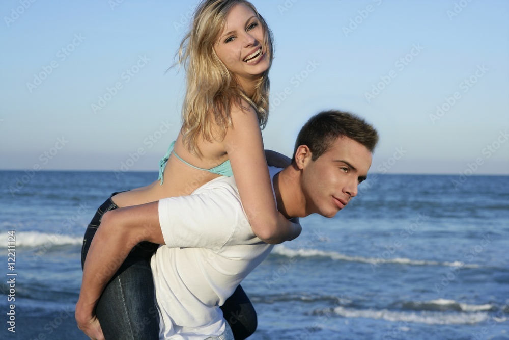 Young beautiful couple playing on the beach Young beautiful couple playing on the beach