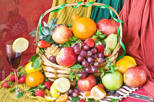 Basket with fruit and a wine glass