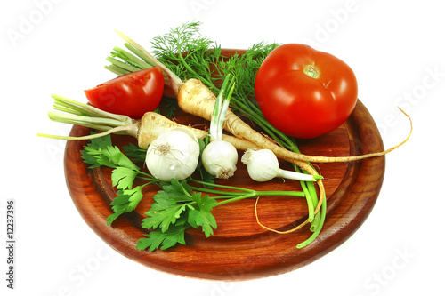 vegetables with tomato on wooden plate