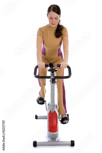Attractive woman doing fitness on a stationary bike