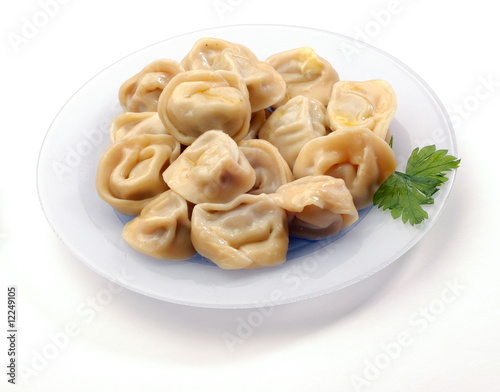 Ravioli on the plate on white background