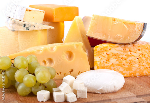 big group of cheeses with white grapes
