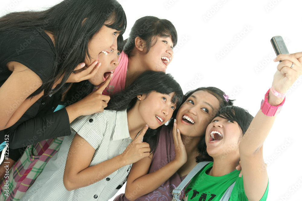 group of young woman fun on mobile phone group of young woman fun on mobile phone