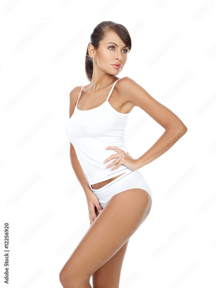 Young beautiful woman in white fitness clothing Young beautiful woman in white fitness clothing