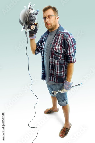 Serious workman with circular saw and wrench on white background photo