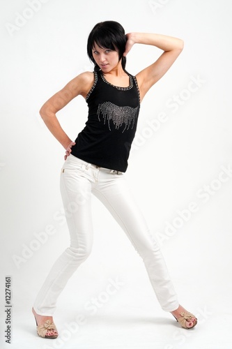Attractive young woman in white jeans