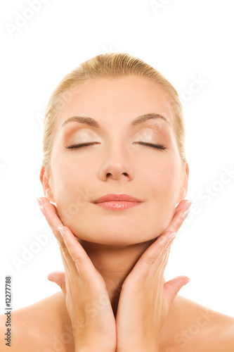 Beautiful young woman massaging her face
