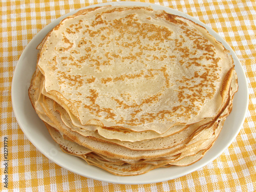 pancakes pile on yellow tablecloth