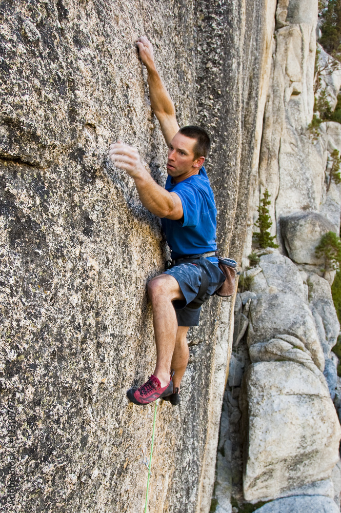 Rock climbing a sheer face.