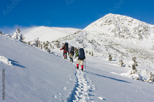 Hiker are in winter mountains © Maygutyak