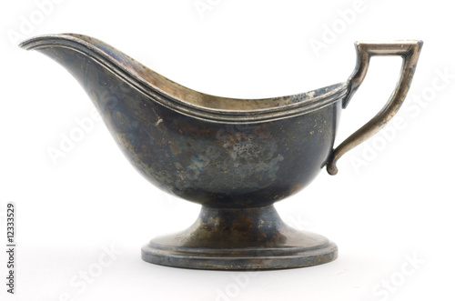 Фотография Vintage silver plated gravy dish with a tarnished surface.