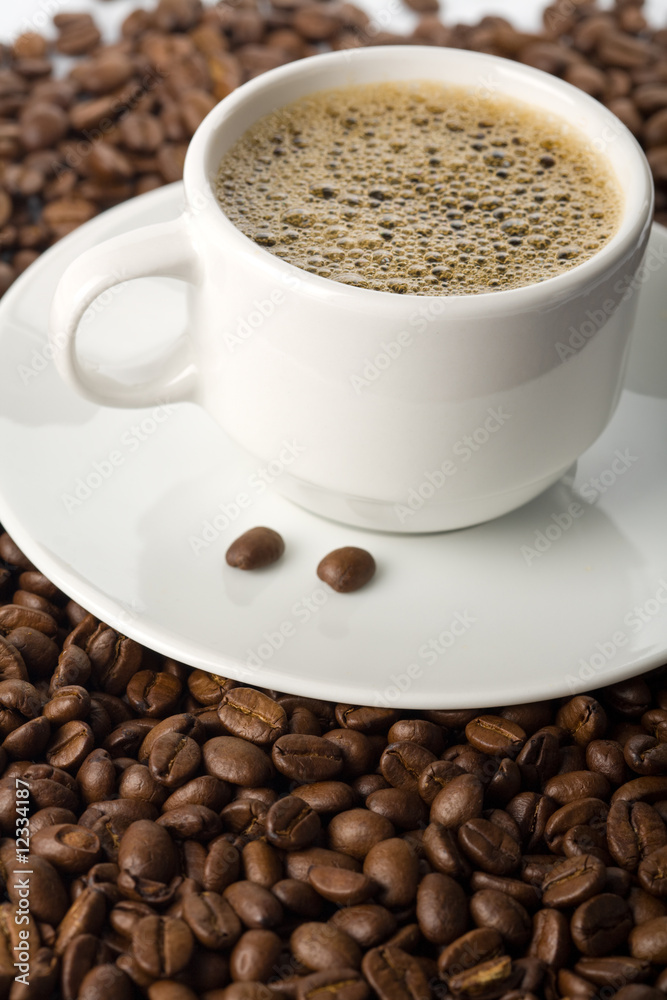 white cup of coffee and coffee beans white cup of coffee and coffee beans