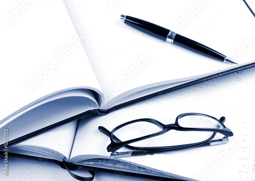 Pen and planner on white background