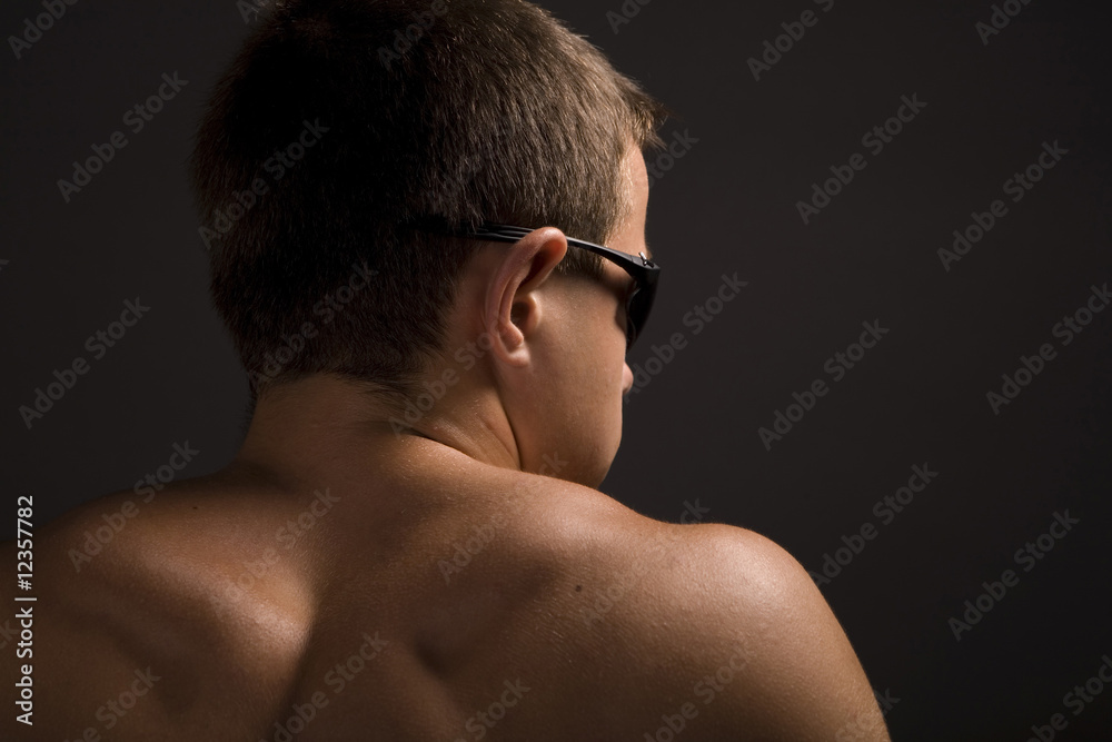 Naklejka premium young sporty man over black background