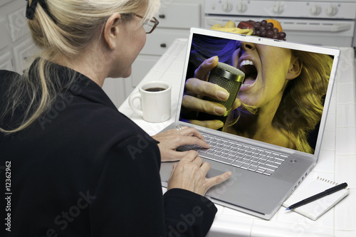 Woman In Kitchen Using Lapt...