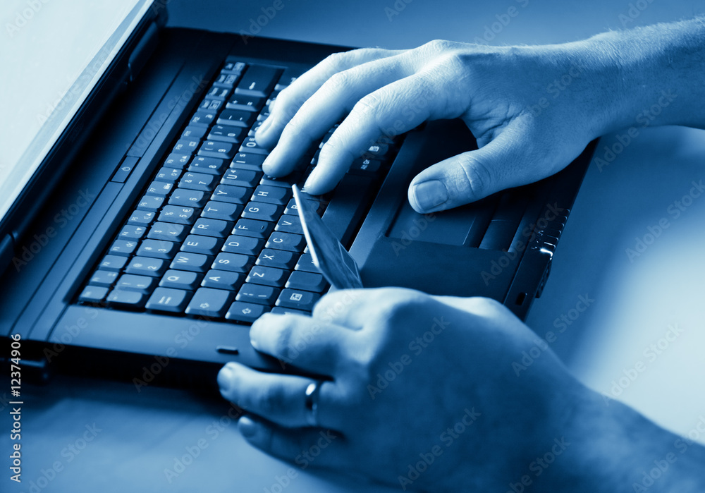 hands holding credit card on keyboard hands holding credit card on keyboard