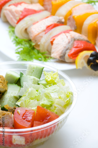 Bowls with vegetarian salad and shish kebab