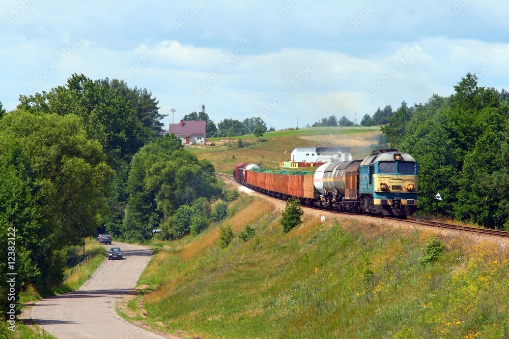 Freight train passes the village