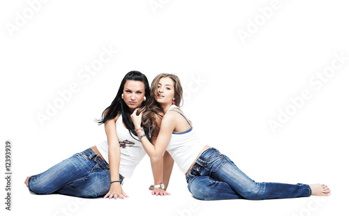 two girlfriends wearing blue jeans isolated with copy space