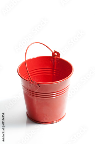 Closeup of small metal bucket painted red, small paint chip.