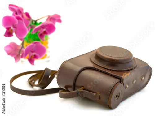 old photocamera accessories and pink orchid