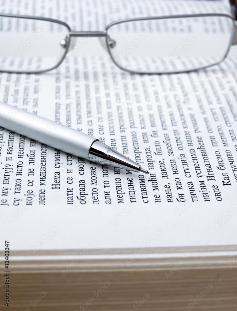 silver glasses, pencil,and books
