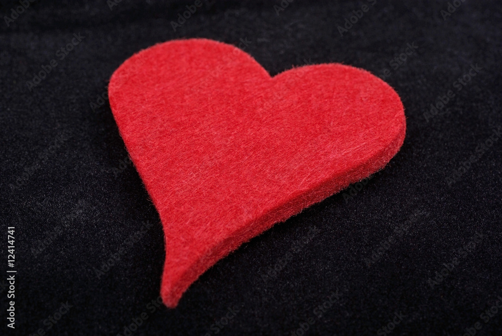 Obraz premium Close up of red heart isolated on black velvet background. Studi