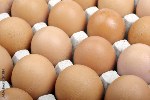 Brown eggs in cardboard package macro as background or backdrop.