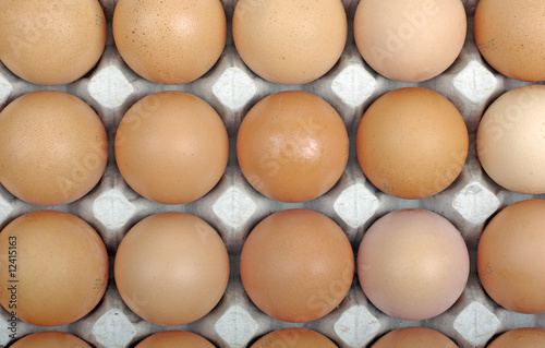 Eggs in cardboard package as background or backdrop.